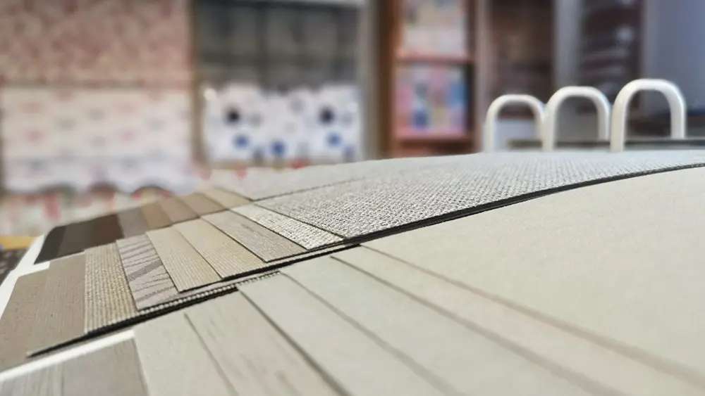 Close-up of fabric sample swatches in our showroom, showing a range of textures and neutral tones