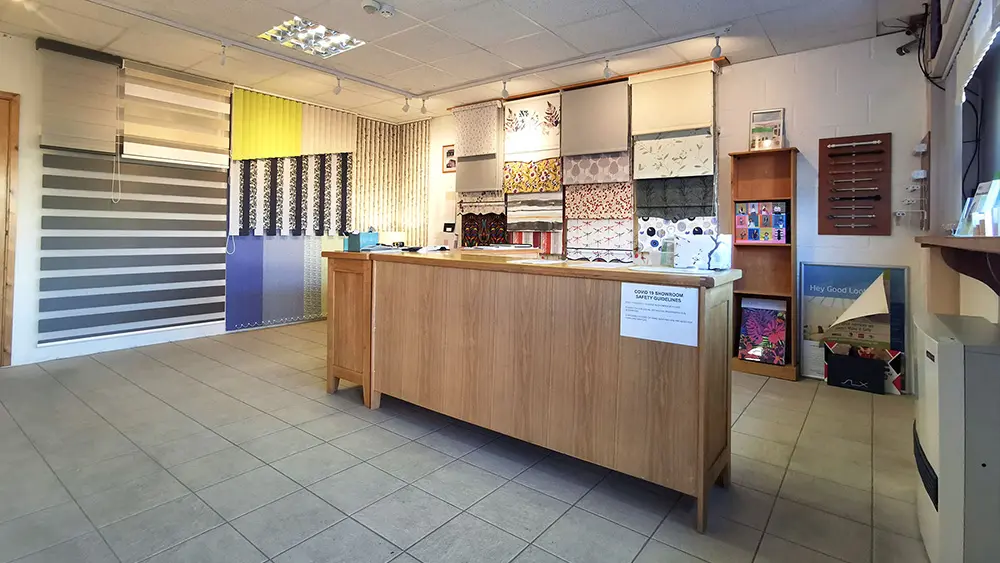 Inside the 1 Stop Blinds showroom — blind displays, fabric samples, and the reception counter