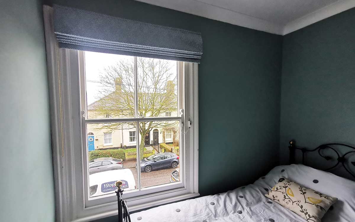 Roman blind installed in a bedroom