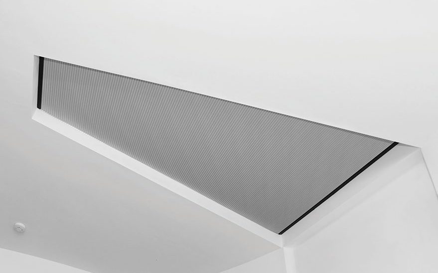 Skylight blind closed across a flat rooflight