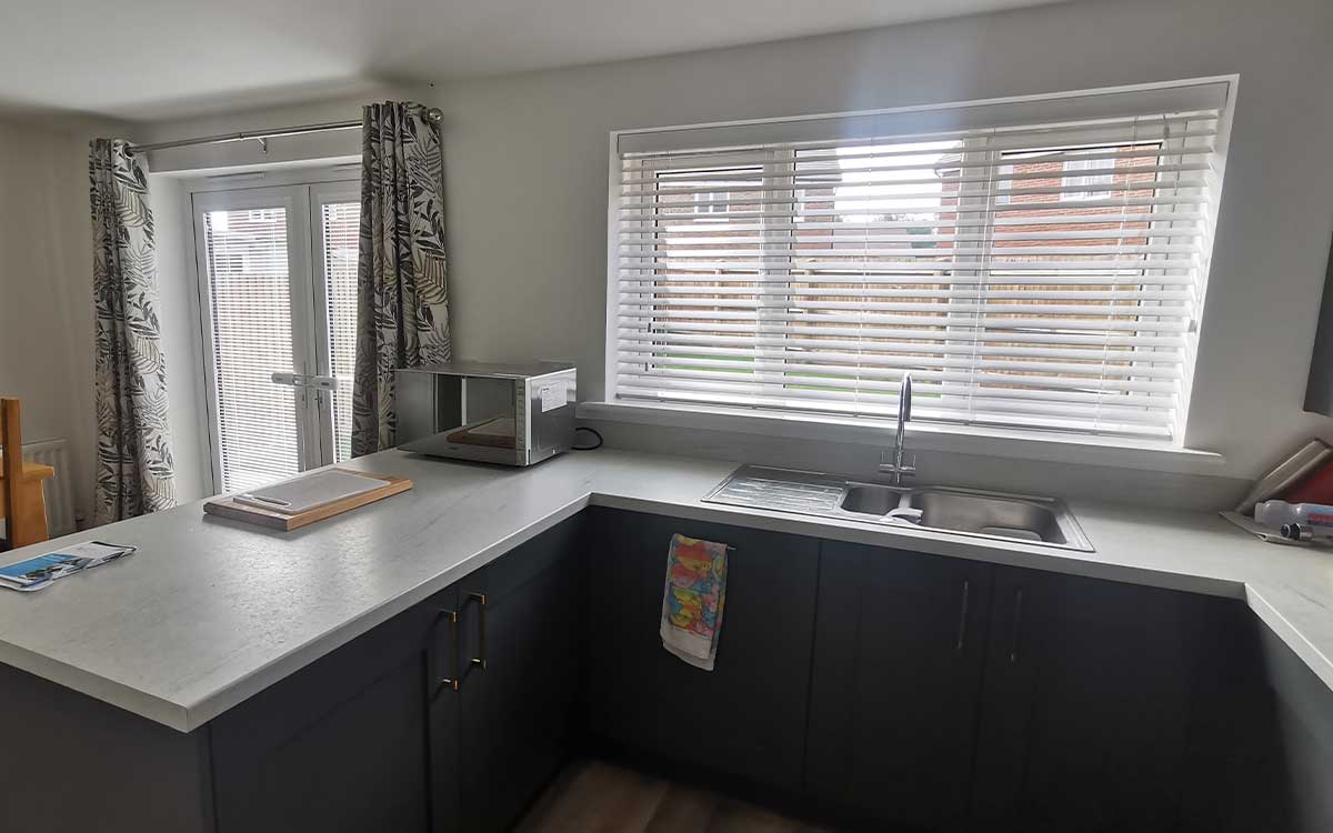 Faux wood blinds installed in a bathroom