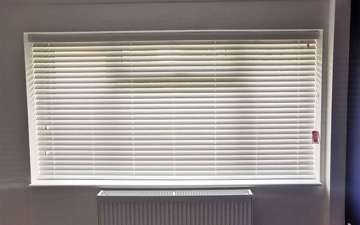 Dark wood blinds in a home office